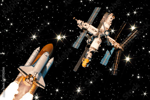 Rocket is flying to the space station. The elements of this image furnished by NASA.