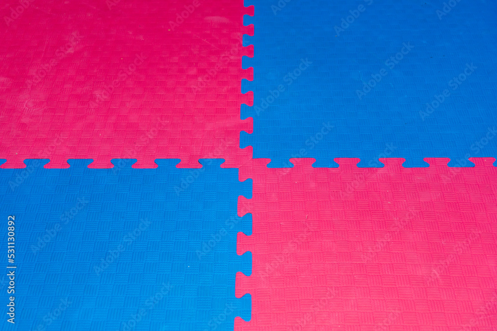 Eva foam rubber floor puzzle mats texture, colorful floor mat background.  Multicolored soft elements. Blue and pink puzzles connected Stock Photo |  Adobe Stock