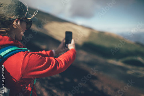 Woman backpacker taking photo with smart phone © yossarian6
