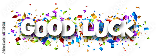 Good luck sign over colorful cut ribbon confetti background.