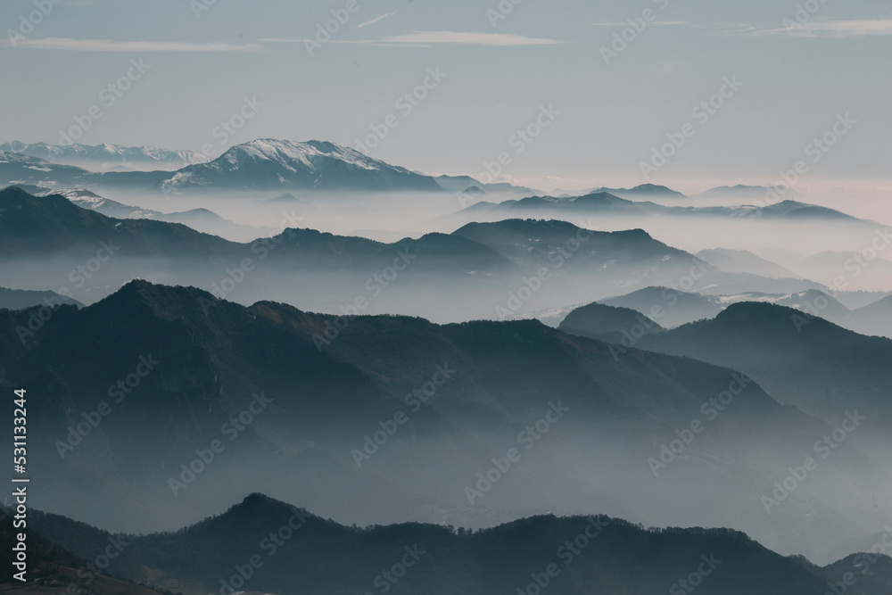 misty layers of mountains in the morning at sunrise