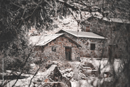 old stone houses in the winter forest with snow © Francesca Emer