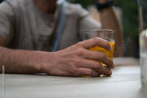 A man hand holding a glass