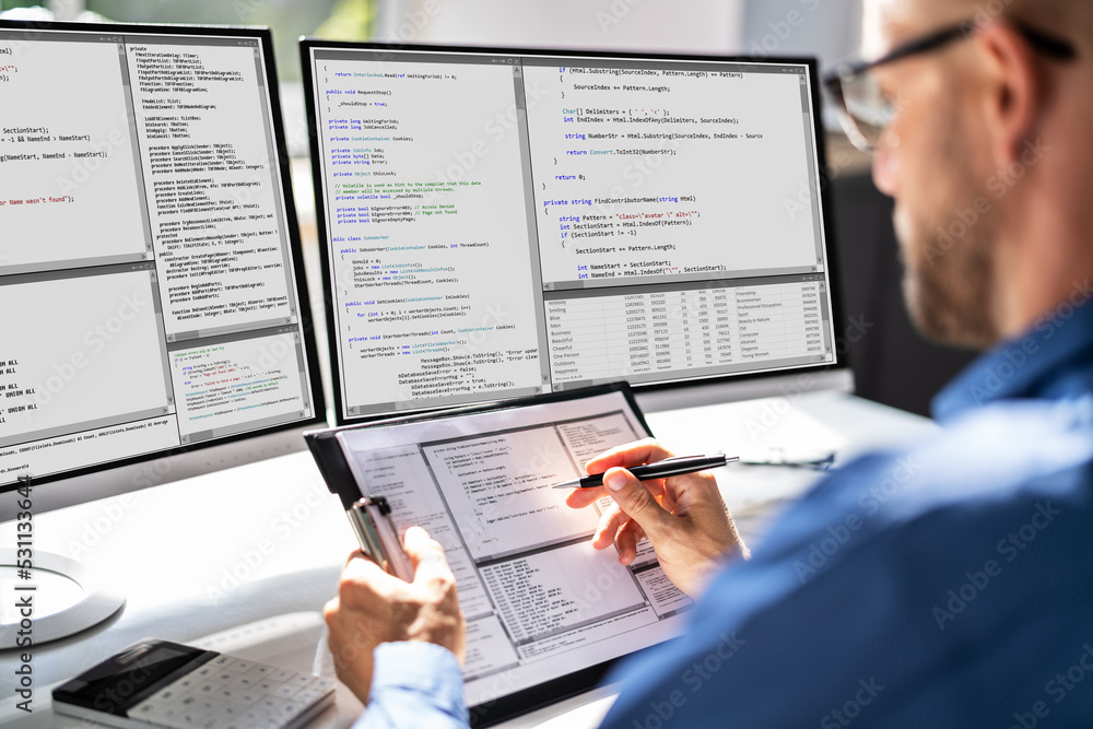 Computer Programmer Writing Program Code On Computer Computer Programmer Writing Program Code On Computer