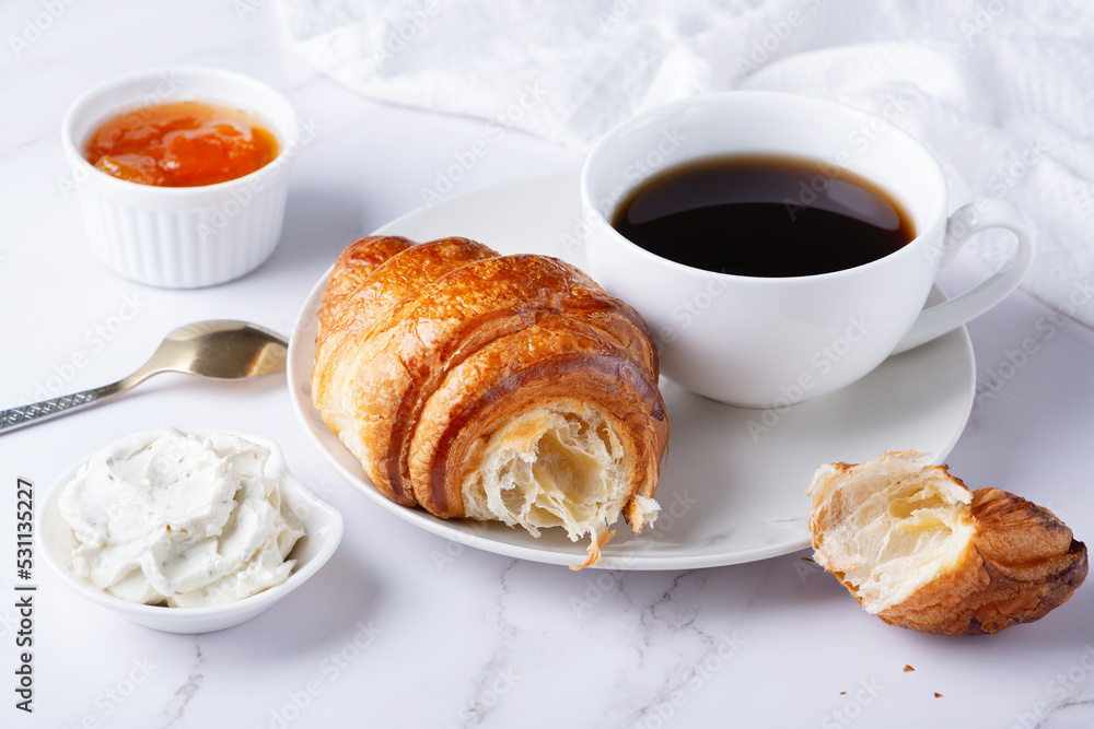 Fresh sweet croissants with cottage cheese and apricot jam for breakfast. Continental breakfast on a white table