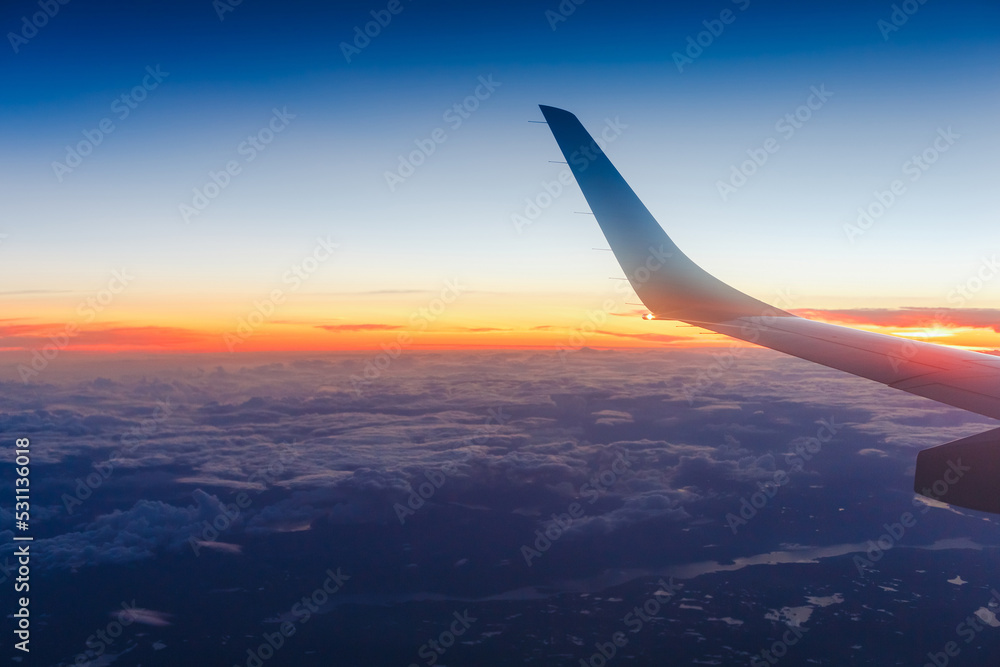 Wing of an airplane in the sunset Wing of an airplane in the sunset