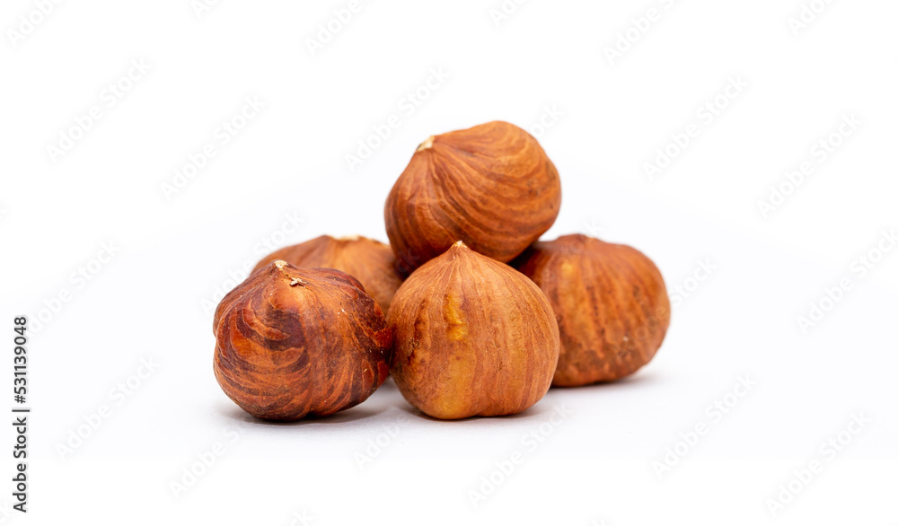 Heap of hazelnuts close-up. Peeled nuts. Hazelnut isolated on white background. Heap of hazelnuts close-up. Peeled nuts. Hazelnut isolated on white background.