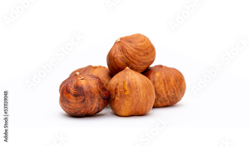 Heap of hazelnuts close-up. Peeled nuts. Hazelnut isolated on white background.