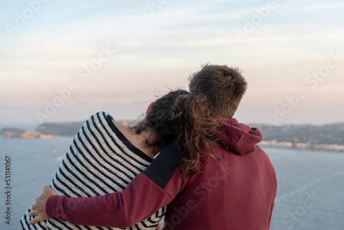 Rear view of unrecognizable couple sitted together 