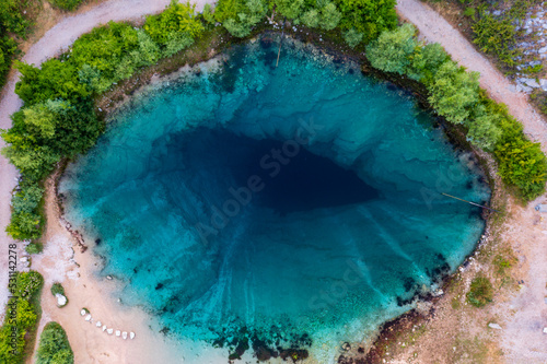 Aerial top down view about Cetina River Spring (Izvor Cetine), also known as the Eye Of The Earth is an incredible karst spring located at the foothills of the Dinara mountain range in Croatia.