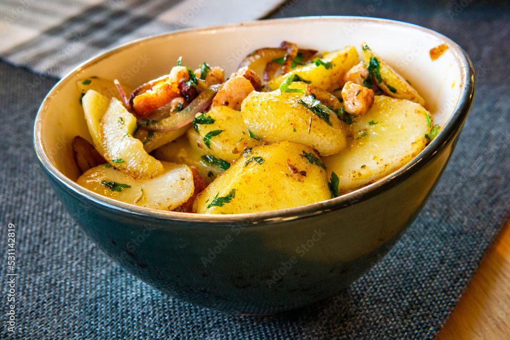 Potatoes fried with bacon and onion in a dish Potatoes fried with bacon and onion in a dish