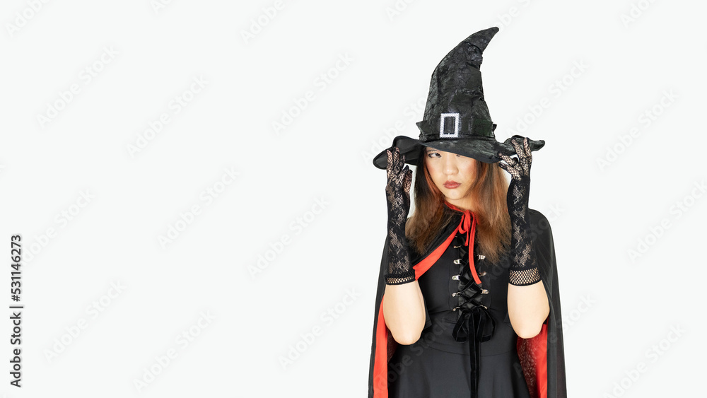 Beautiful girl in witch costume and witch hat is over isolated white background Beautiful girl in witch costume and witch hat is over isolated white background