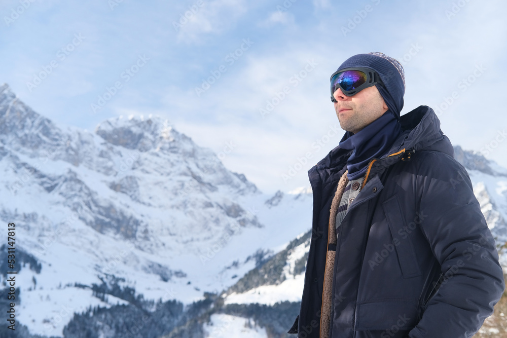 young man wearing sunglasses, mountain hiker admiring mountain winter landscape, Sports Concept, Healthy Lifestyle, Winter Activity, beautiful winter natural landscape, walks in winter white forest