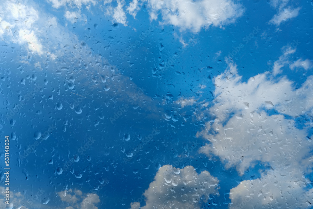 beautiful cloudscape in window, blue texture of glass background with water drops, place for text, horizontal banner with blurry bokeh, nature protection, Severe Weather beautiful cloudscape in window, blue texture of glass background with water drops, place for text, horizontal banner with blurry bokeh, nature protection, Severe Weather