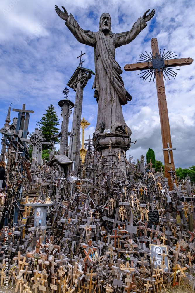 Fototapeta premium Jesus statute on the Hill of Crosses. Wooden crosses. A pile of crosses.