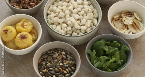 Ingredients for pozole verde soup: hominy, New Zealand spinach, roasted pumpkin seeds, roasted white onion, roasted poblano pepper, roasted tomatillo, shredded and roasted jackfruit, fried shiitake. photo