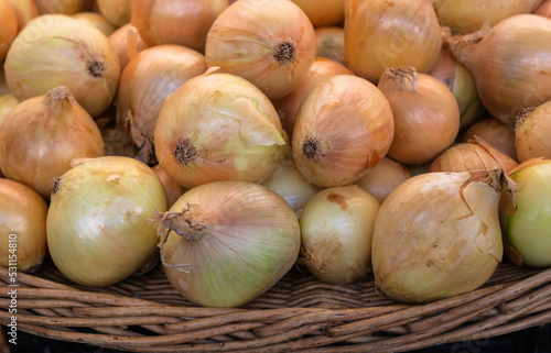 Close up of fresh white onions  in a basket at the market