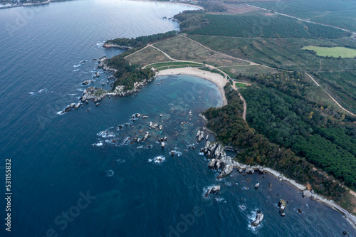Aerial view of beautiful bay with rocks and blue water © Aytug Bayer