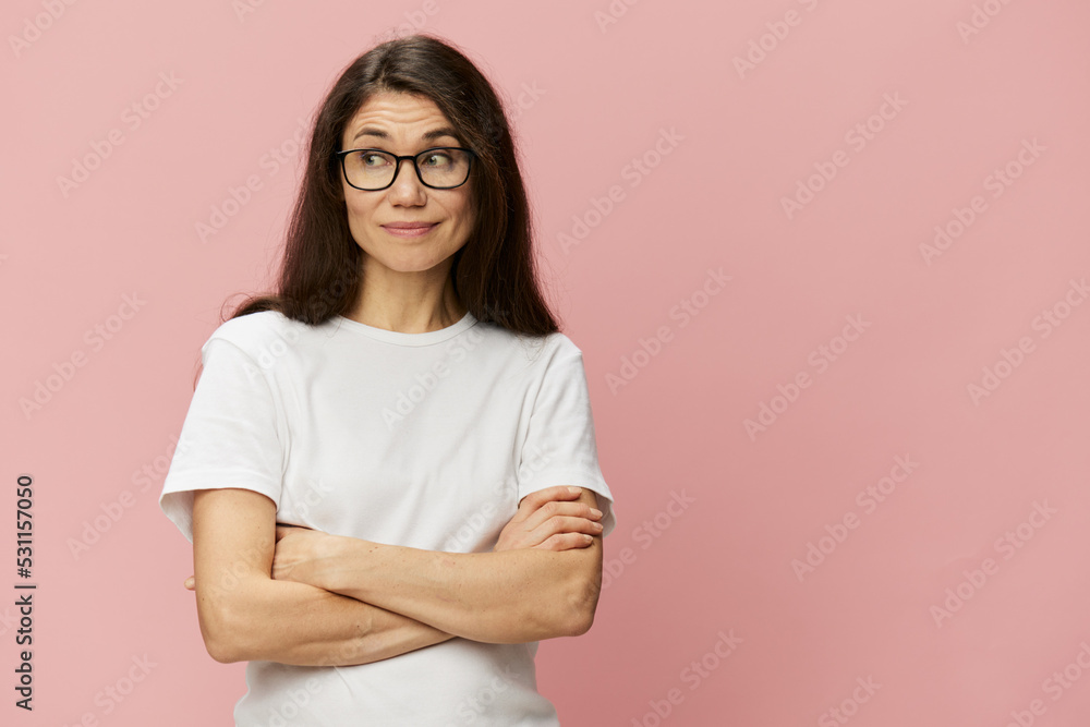portrait of a cute, attractive brunette in a white tank top on a pink background, with a pleasant smile, standing in glasses for vision portrait of a cute, attractive brunette in a white tank top on a pink background, with a pleasant smile, standing in glasses for vision