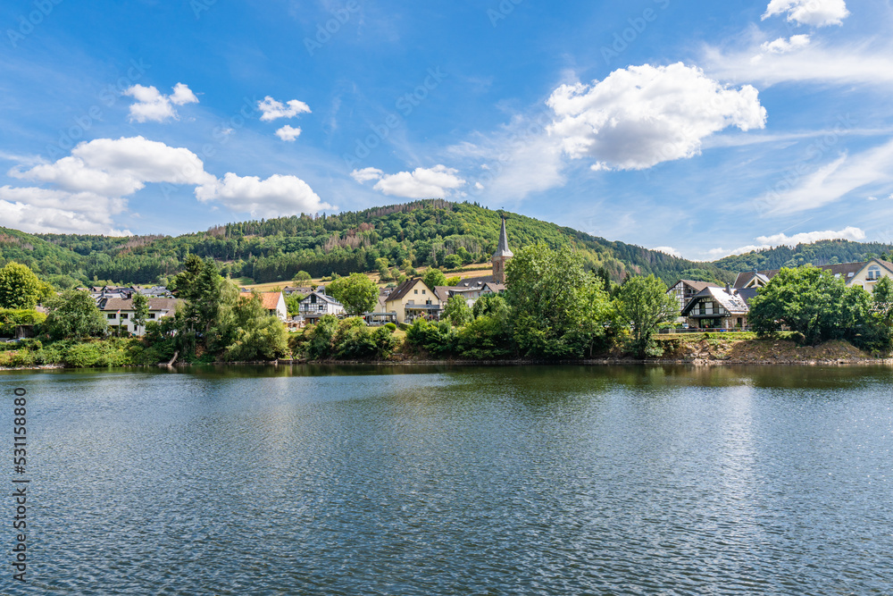 Some houses at the shore of lake Rursee, In the middle of the Eifel National Park, surrounded by unique natural scenery and unspoilt nature