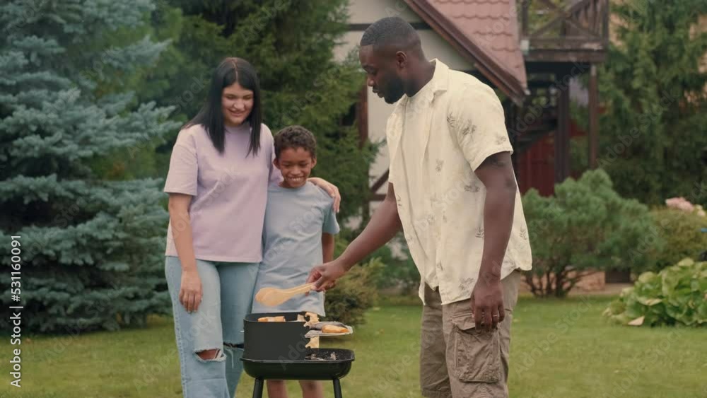 An African dad cooks krill vegetables for his multi-ethnic family.Multiracial Family,Mixed Race,Diverse People,Multiethnic Relations An African dad cooks krill vegetables for his multi-ethnic family.Multiracial Family,Mixed Race,Diverse People,Multiethnic Relations