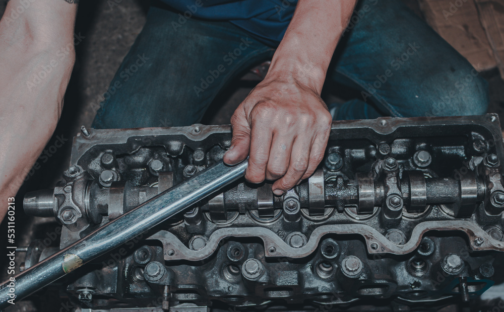 Fototapeta premium The mechanic is checking the engine.