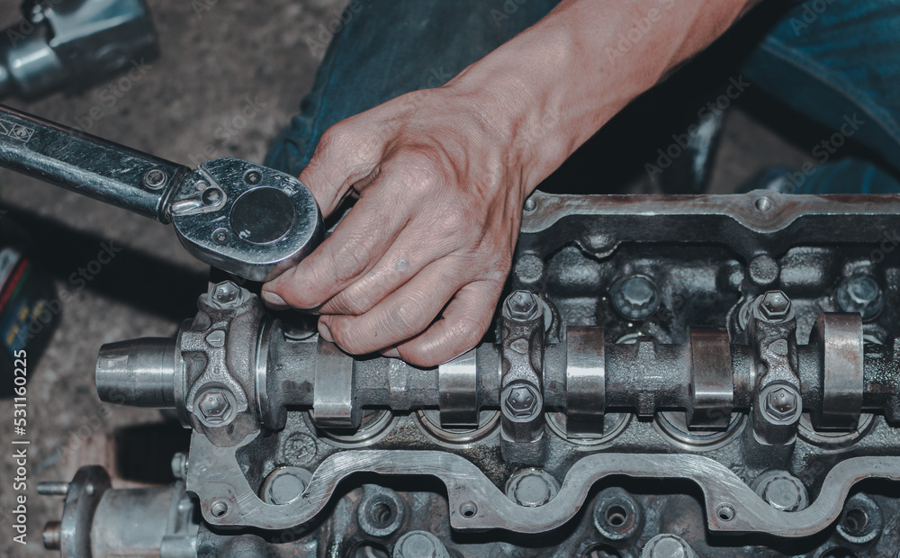 The mechanic is checking the engine. The mechanic is checking the engine.