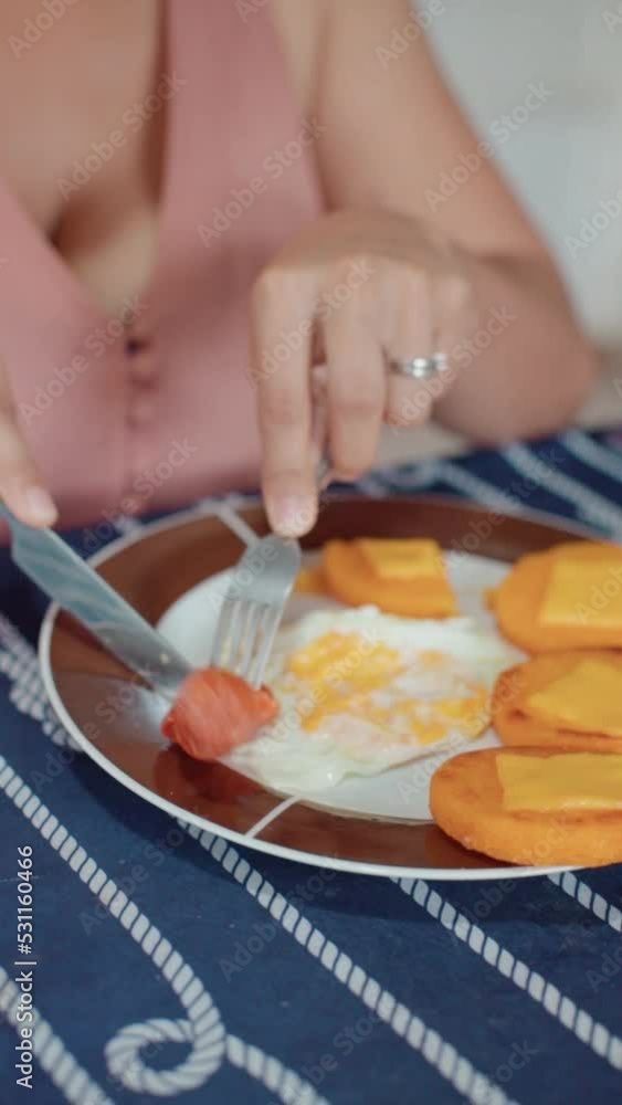 person eating an omelet with egg and sausage, close-up person eating an omelet with egg and sausage, close-up