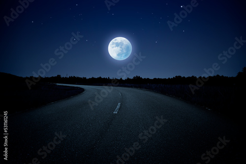Empty winding road in blue night