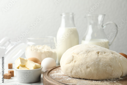 Fresh dough for pastries on white marble table