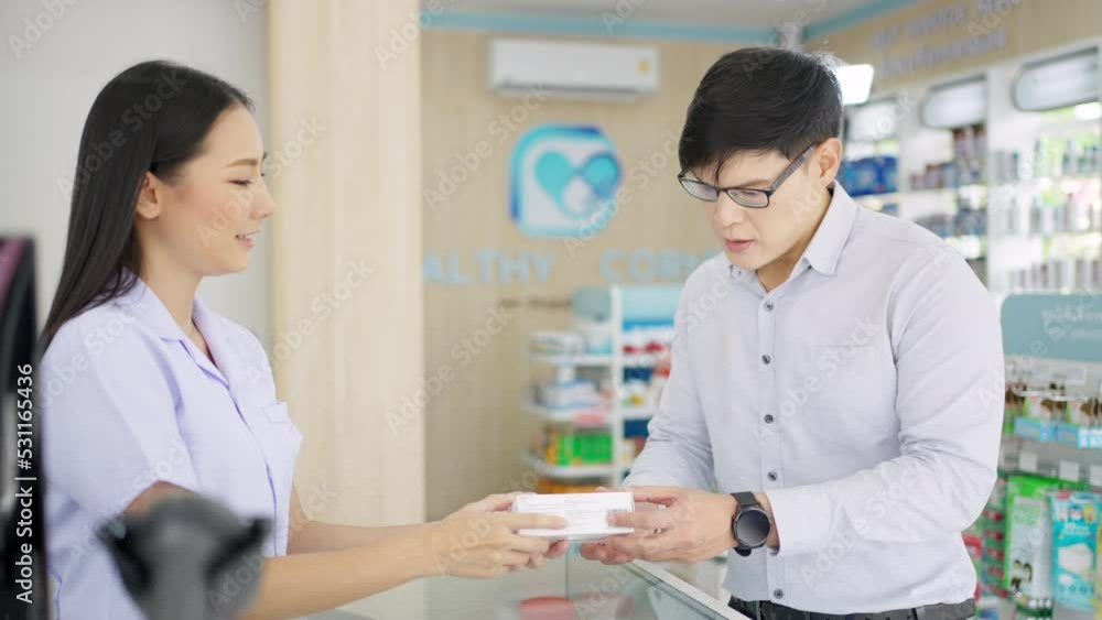 4K Attractive Asian woman pharmacist medication recommendation about medicine, drugs and supplements to male patient customer in modern drugstore. Medical pharmacy and healthcare providers concept. 4K Attractive Asian woman pharmacist medication recommendation about medicine, drugs and supplements to male patient customer in modern drugstore. Medical pharmacy and healthcare providers concept.