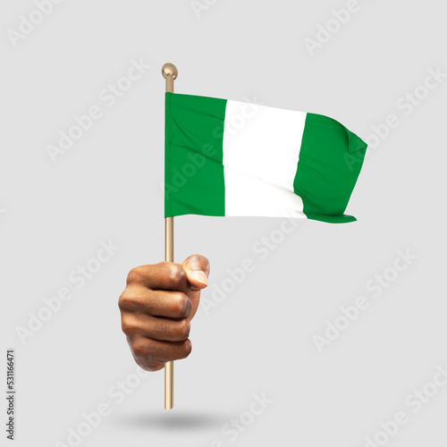 Hand holding Nigerian national flag isolated on gray background photo