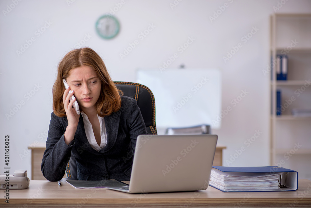 Young female employee working in the office Young female employee working in the office