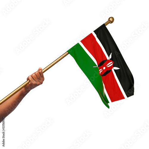 Hand holding Kenyan national flag isolated on gray background photo