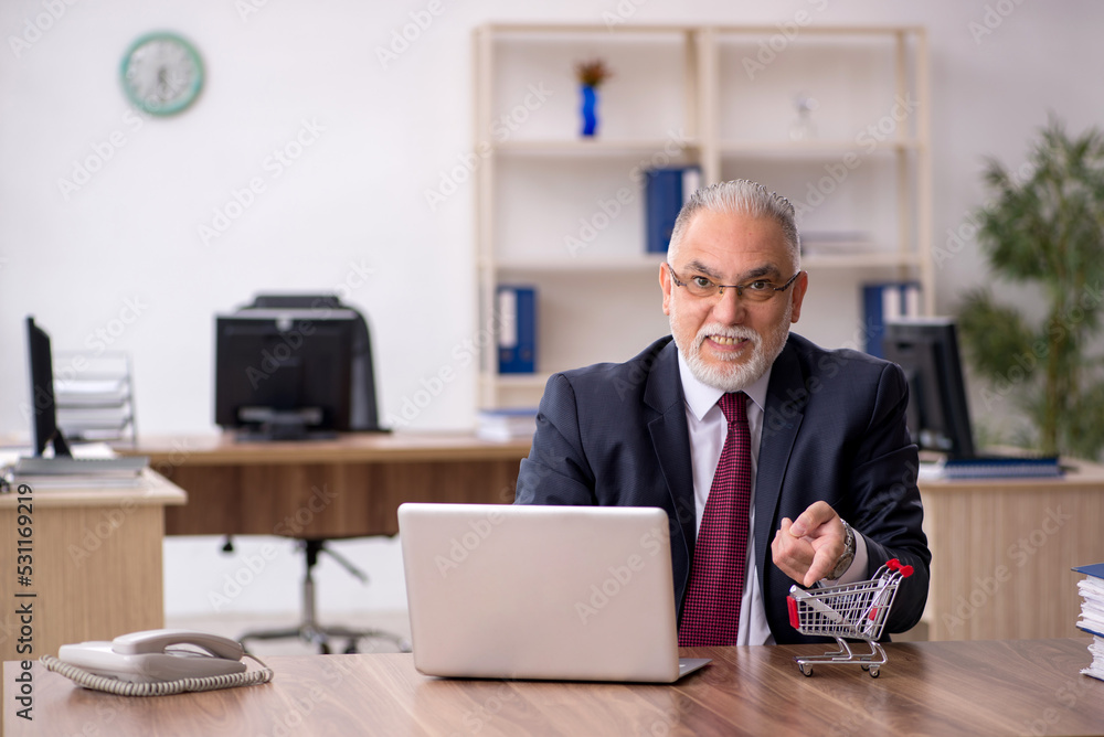 Old male employee in e-commerce concept Old male employee in e-commerce concept