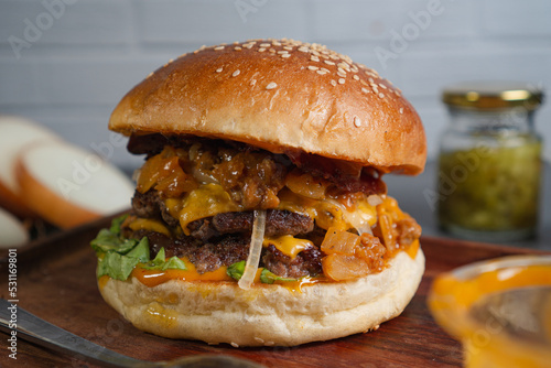 closed up smash beef burger with cheese, coney sauce on wooden table