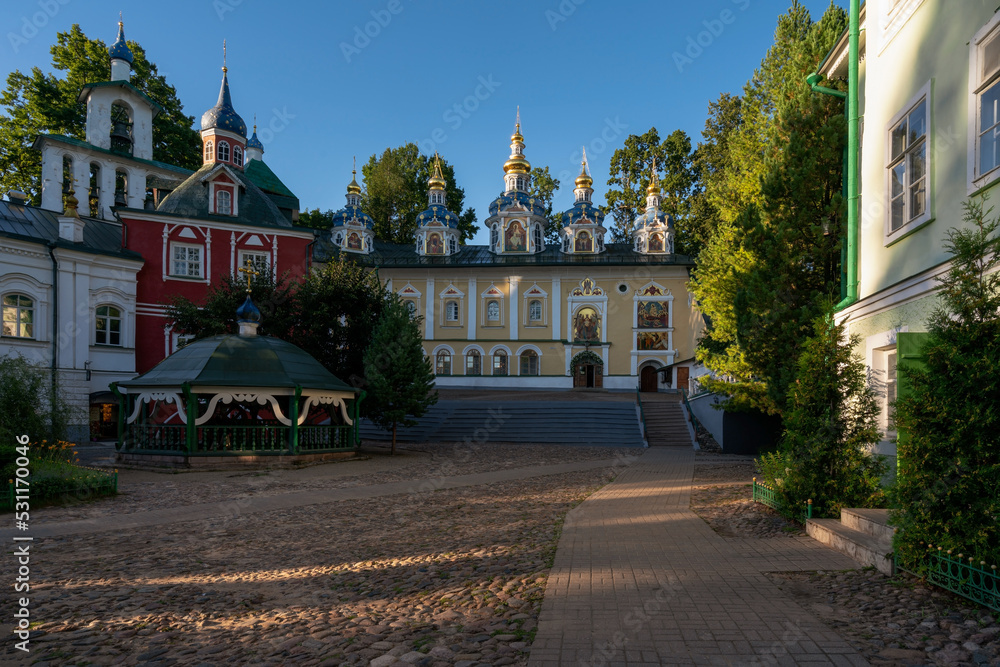 View of the Assumption Cathedral, the Great Belfry and the sacristy in the Holy Dormition Pskov-Pechersk Monastery on a sunny summer day, Pechory, Pskov region, Russia