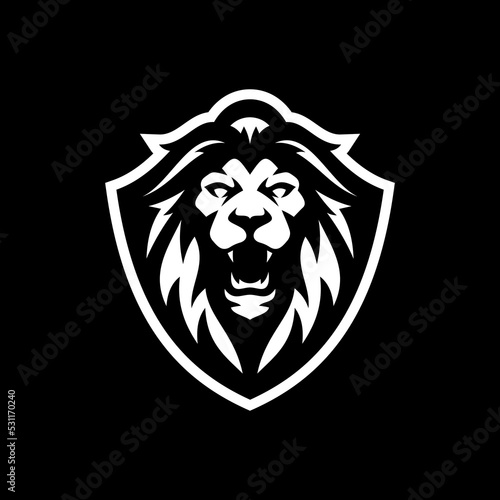 Fototapeta Naklejka Na Ścianę i Meble -  Lion head and shield mascot emblem logo illustration on dark background
