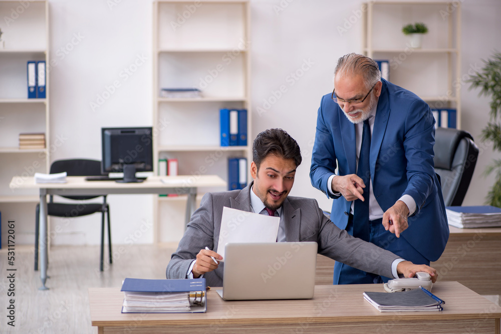 Two male colleagues working in the office Two male colleagues working in the office