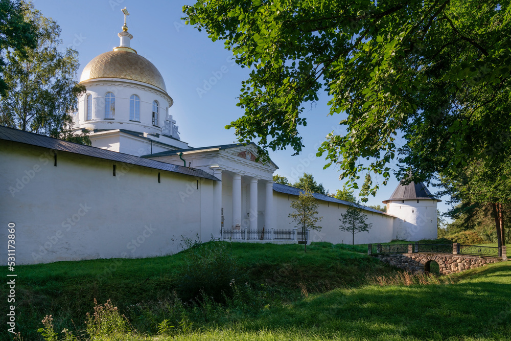 View of the outer wall of the Holy Dormition Pskov-Pechersk Monastery and St. Michael's Cathedral on a sunny summer day, Pechora, Pskov region, Russia View of the outer wall of the Holy Dormition Pskov-Pechersk Monastery and St. Michael's Cathedral on a sunny summer day, Pechora, Pskov region, Russia