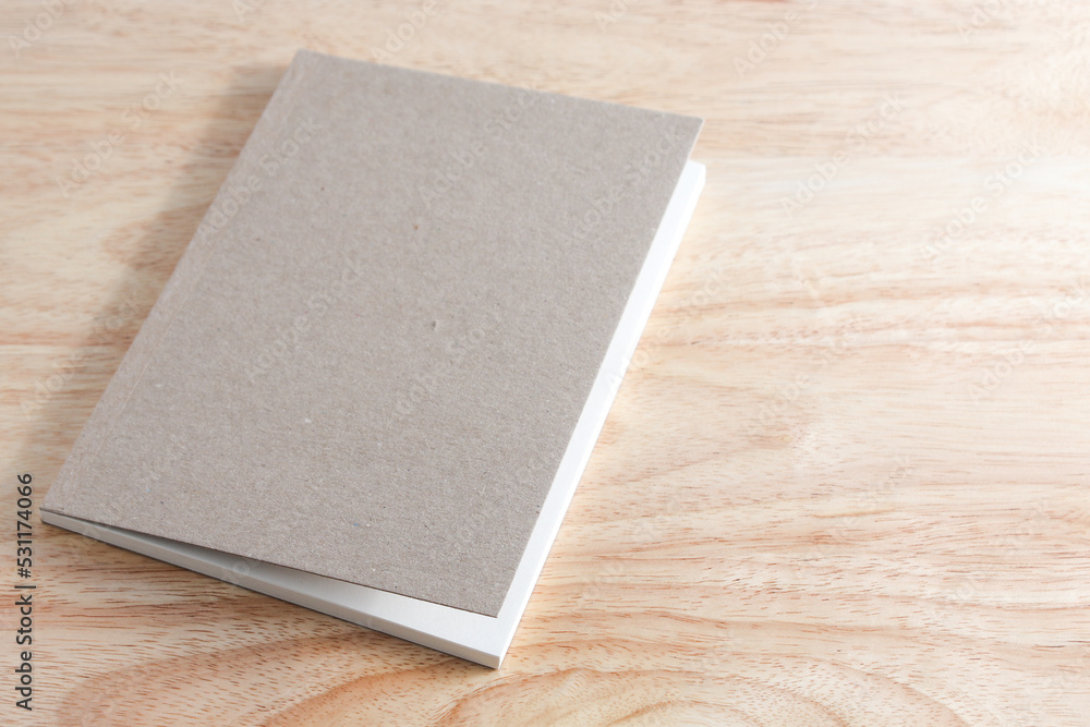 Recycled paper book on wooden background Recycled paper book on wooden background