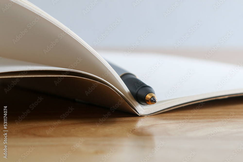 pen and book on wood background pen and book on wood background