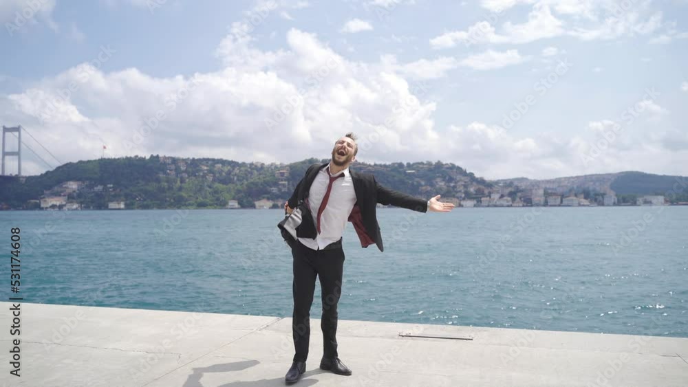 Businessman reaching his goal rejoicing by the sea.
Businessman rejoicing for his success against the Bosphorus view in the city. He has achieved his goal and is happy.
Businessman reaching his goal rejoicing by the sea.
Businessman rejoicing for his success against the Bosphorus view in the city. He has achieved his goal and is happy.