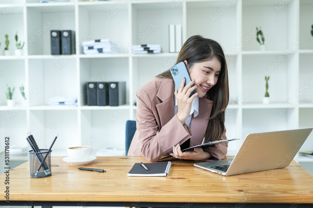 Asian business woman Use a laptop computer and work at the office ready. plan to analyze financial reports Asian business woman Use a laptop computer and work at the office ready. plan to analyze financial reports
