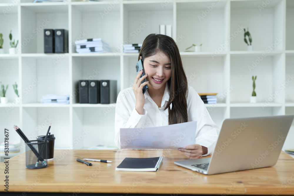 Asian business woman Use a laptop computer and work at the office ready. plan to analyze financial reports Asian business woman Use a laptop computer and work at the office ready. plan to analyze financial reports