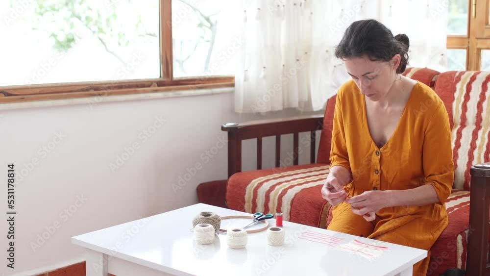 Thread Feather, DIY Home Decor, Handmade Yarn Decoration, Woman Making Dream Catcher Feather, Making a feather from thread, scissors on the table Thread Feather, DIY Home Decor, Handmade Yarn Decoration, Woman Making Dream Catcher Feather, Making a feather from thread, scissors on the table
