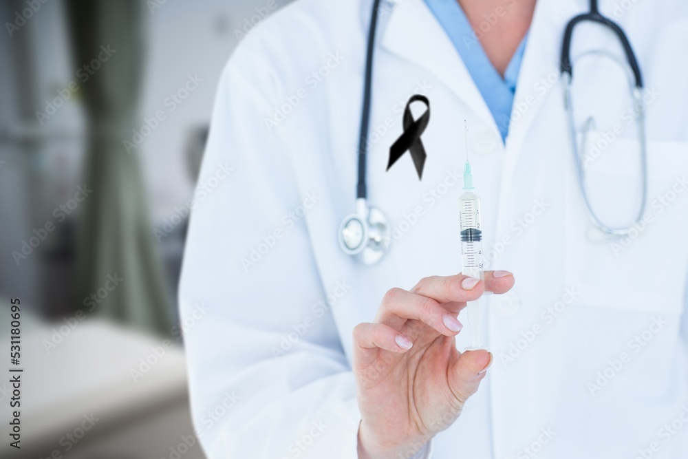Mid section of doctor with black ribbon on robe holding a syringe in the hospital Mid section of doctor with black ribbon on robe holding a syringe in the hospital