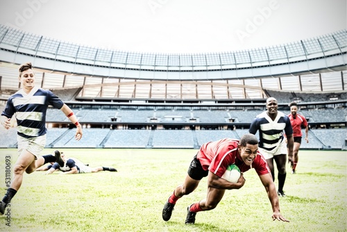 Digital composite image of rugby player jumping with the ball to score touchdown in sports stadium