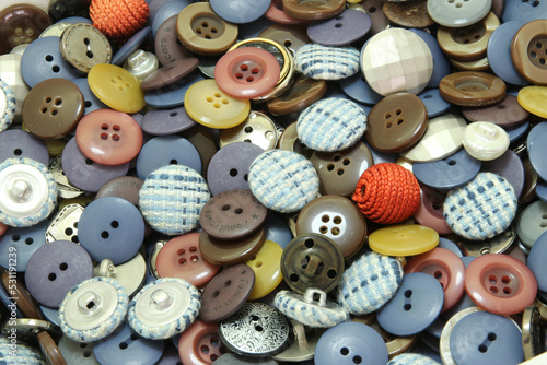 Multi-colored sewing buttons of different sizes and shapes background