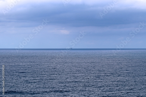 Fototapeta Naklejka Na Ścianę i Meble -  Horizon line over the sea, with a boat that is seen from afar